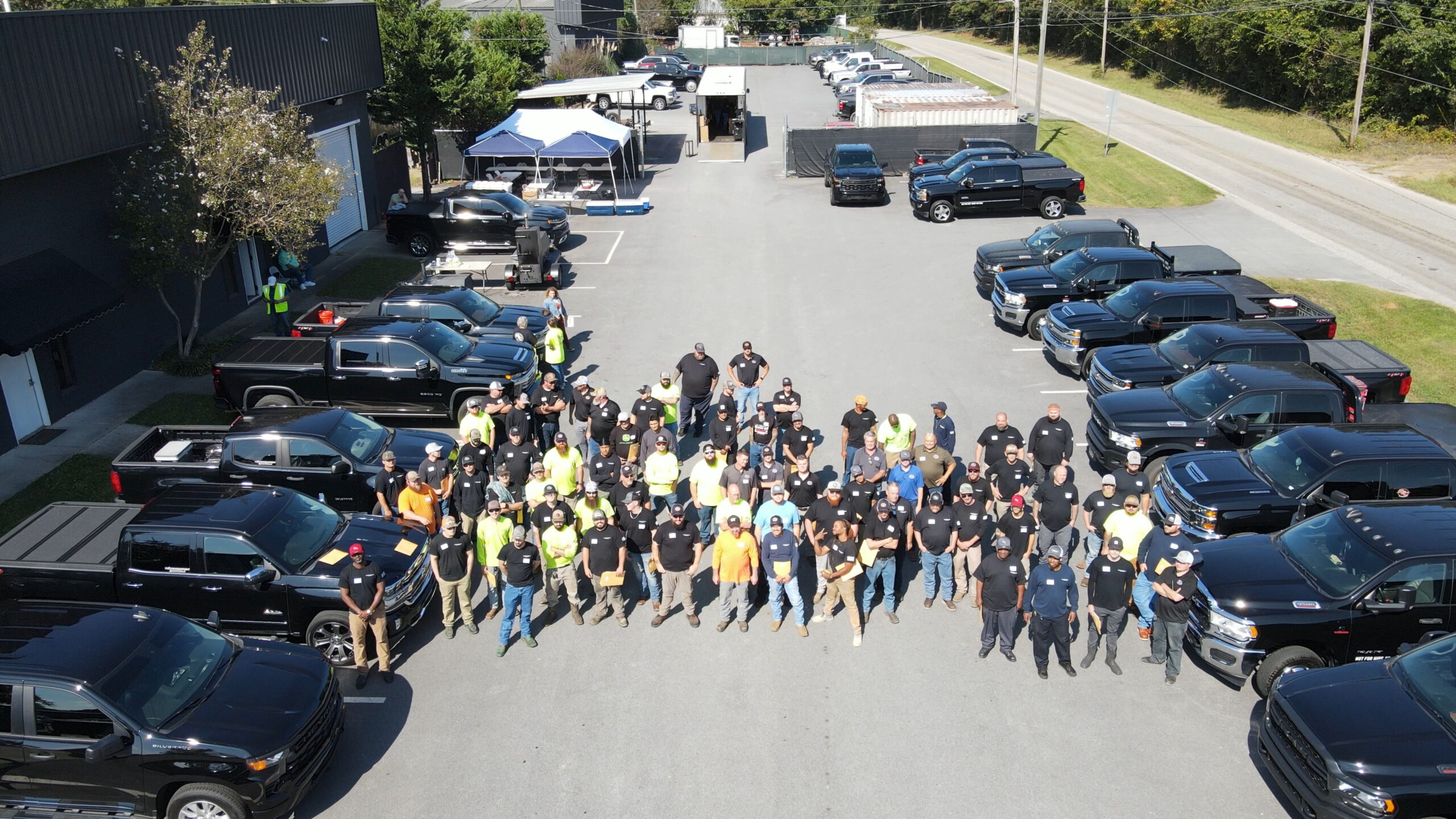 The PEC team - drone shot in parking lot with PEC trucks