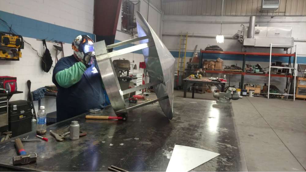 PEC welder working on vent hood repair