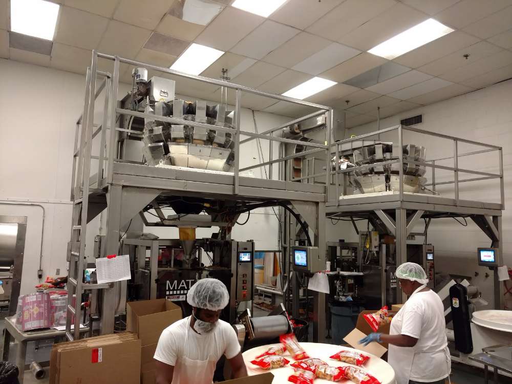 employees working in production line at food manufacturing plant