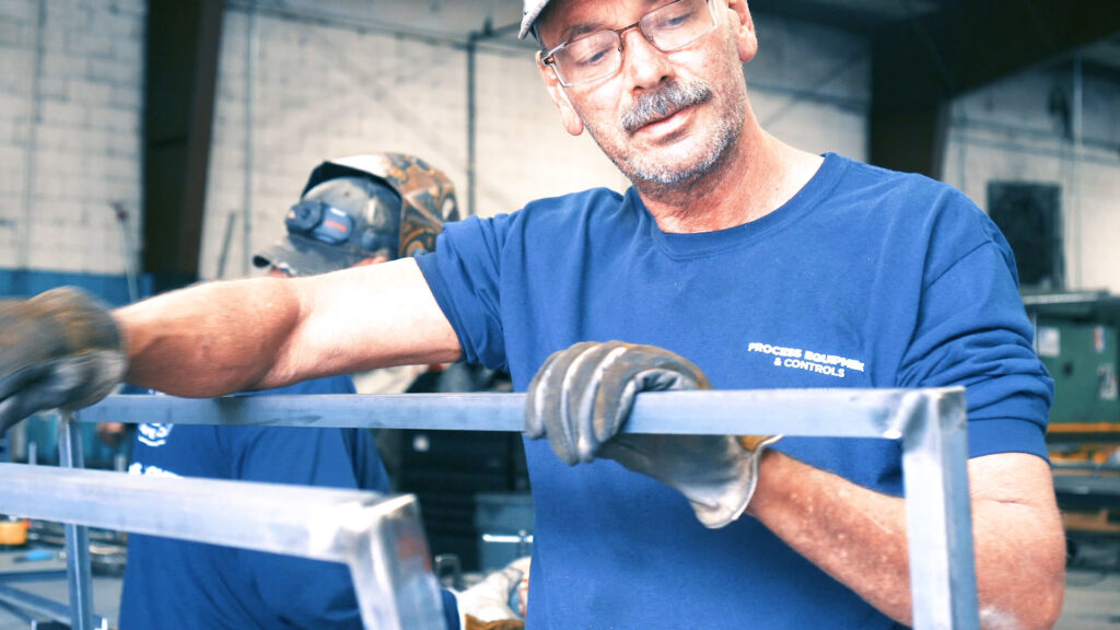PEC – Custom Metal Fabricator working on a frame