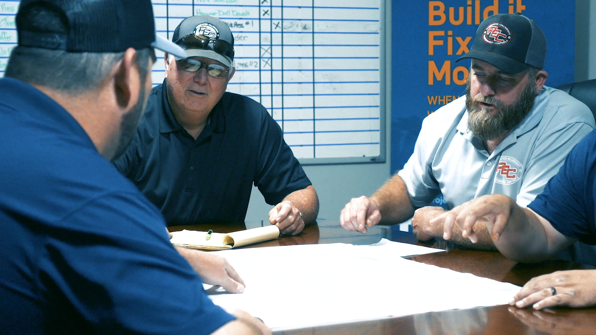 PEC's project management team working at conference table