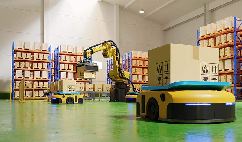 AMRs Autonomous Mobile Robots with cardboard boxes and a Automated Palletizer system in the background