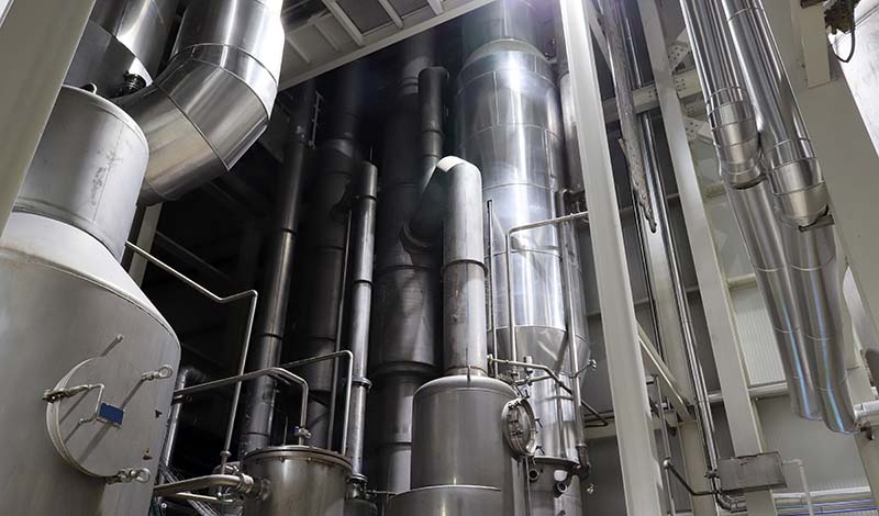 process piping and holding tanks in a dairy processing plant