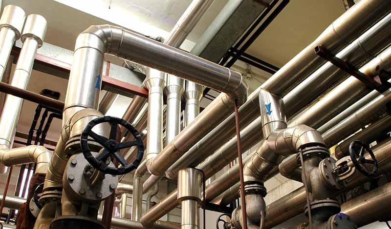 complex process piping system with valves and gauges that require facility maintenance