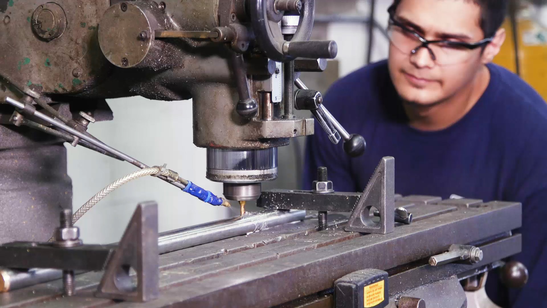 PEC employee observing industrial equipment