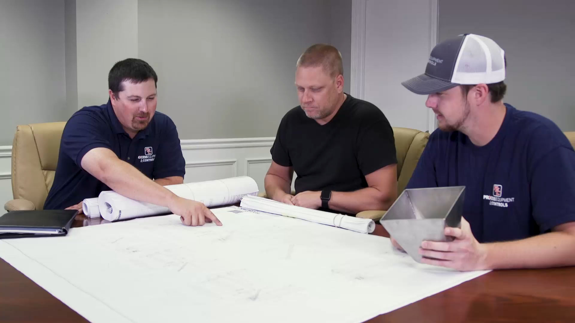 PEC employees reviewing plans at a conference table | Statesboro Mechanical Contractor