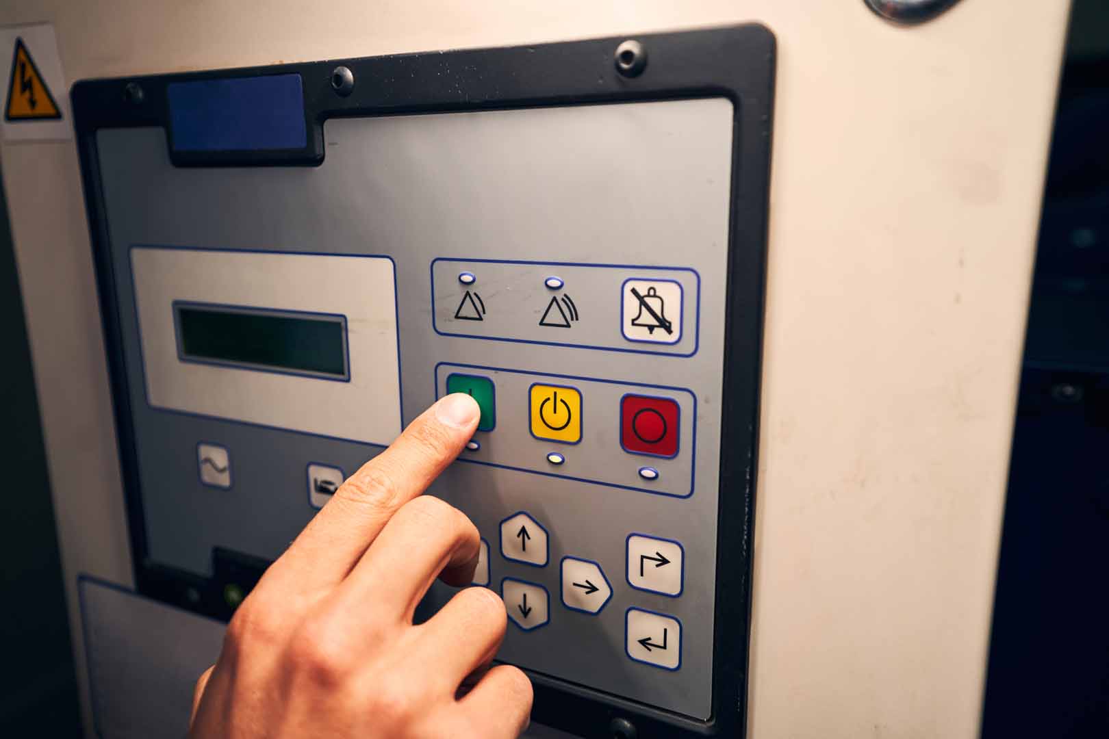 Cropped photo of adult male hand pressing button on control panel